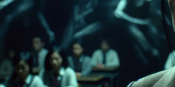 A female teacher in a dim classroom, expressing determination and sorrow amidst shadows and psychological tension.